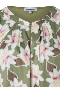 Floral blouse featuring a green base with large pink and cream flowers. It has a round neckline, pleats, and button detail at the front.