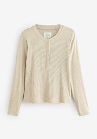 Beige pikendusega henley särk, millel on tekstuuriga ribad, ümar kaelus ja ees nuppe sulgemine. Omab vabalt langevat lõiget ja õmmeldud aktsente.