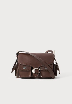 Brown leather crossbody bag with flap closure, silver hardware, double pocket accents, and adjustable strap. Smooth texture with stitching details.