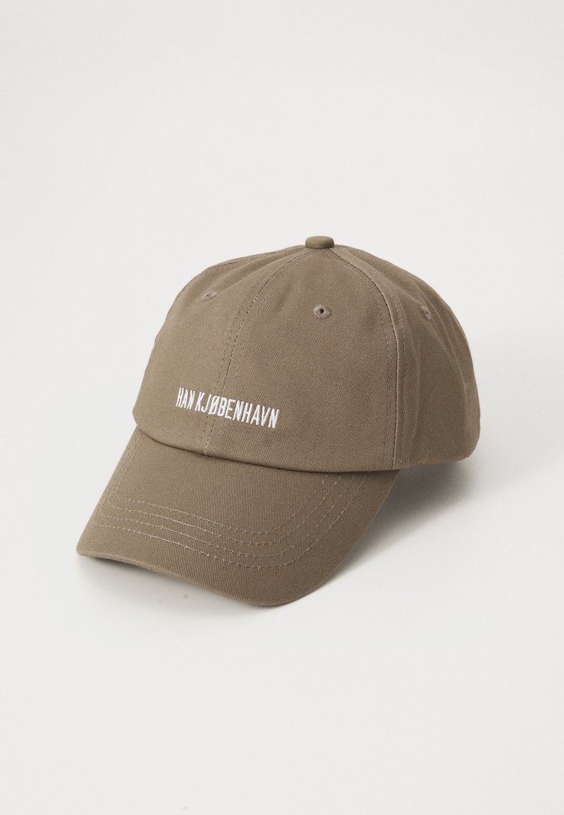 Olive green cotton baseball cap with six panels, embroidered white text "HAN KJØBENHAVN," and a curved visor. Visible stitching details.