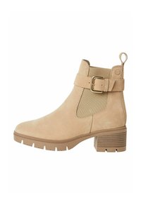 Bottines en daim beige clair avec des panneaux élastiques sur les côtés, un accent en boucle dorée et un talon bloc texturé. Semelle en caoutchouc durable et profilée.