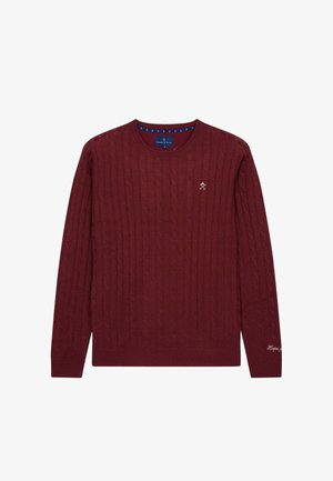 Maglione a collo rotondo di colore bordeaux, lavorato a maglia con motivo a trecce e con polsini a coste. Presenta un piccolo logo ricamato sul petto.
