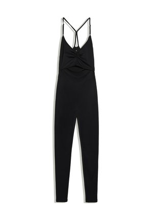 Combinaison une-pièce noire avec jambes ajustées et fines bretelles réglables formant un V dans le dos et un détail torsadé au niveau de la poitrine.