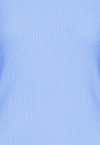 Tessuto a maglia a coste di colore azzurro chiaro che mostra linee verticali testurizzate e leggere ombre.