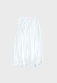 Pantalon blanc ample avec taille élastique et poignets élastiques, présenté sur un fond gris clair uni.