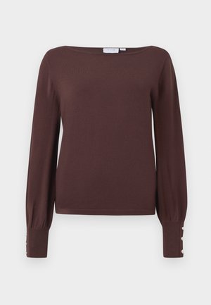 Barna, hosszú ujjú pulóver széles nyakkivágással és puffos ujjal. Az anyag bordázott mandzsettáin három díszgomb található, amelyek további részleteket adnak.