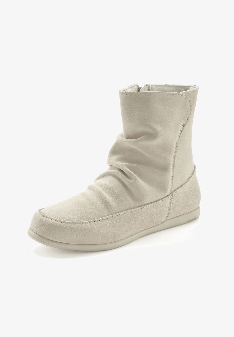Beige suede ankle boot with a slouch design, rounded toe, and a flexible rubber sole. Features a subtle seam detail along the edges.