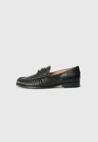 Black leather loafer with a rounded toe, featuring a stitched detail along the front and a small gold accent on the upper. Flat sole.