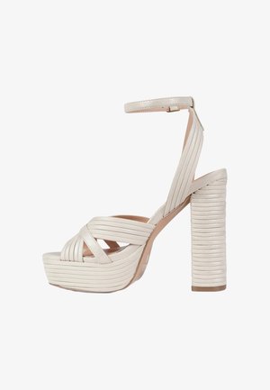 Sandalo beige con tacco alto, cinturini incrociati, cinturino alla caviglia, suola piattaforma e tacco spesso impilato con scanalature orizzontali.