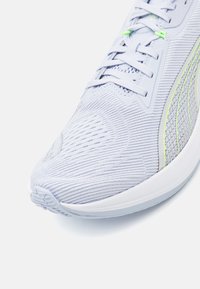 Light blue running shoe with a textured mesh upper, featuring green accents, a rounded toe, and a cushioned white sole.