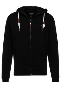Sort zip-up hættetrøje lavet af blødt stof, med en snoretrækshætte, frontlommer og læderdetaljer på lynlåsen og snoretræk.