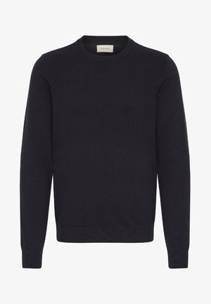 Musta neulepaita, jossa on pyöreä kaula-aukko, pitkät hihat sekä ribbireunat hihoissa ja helmassa. Sujuva pinta ilman näkyviä kuvioita tai koristeita.