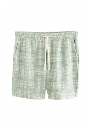 Lysegrønne strikkede shorts med hvide blomsterprint, elastisk talje, hvid snøre og sidelommer.
