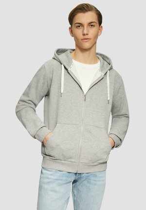 Gray zip-up hoodie with a drawstring hood, features front pockets and ribbed cuffs, worn over a white t-shirt, paired with light blue jeans.