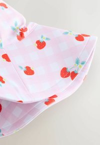 Ružičasta pamučna tkanina s kariranim uzorkom, koja ima crvene jagode i zelene listove. Rubovi su glatko ušiveni; lagana i fleksibilna.