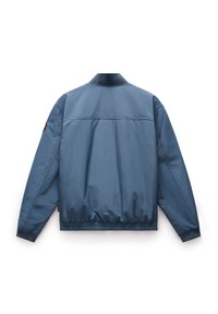 Blauwe bomberjack met een gladde, glanzende afwerking. Beschikt over een geribde kraag, elastische manchetten en een elastische taille. Op één schouder bevindt zich een ronde logopatch.