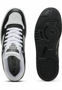 Pantofi sport alb-negru cu talpă din cauciuc texturat, țesătură din plasă, accente din piele și un logo proeminent. Prezintă șireturi în față.