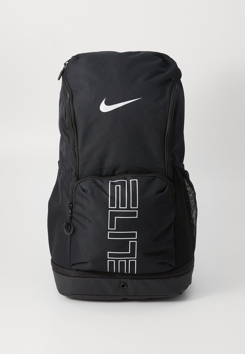 Nike melns mugursoma ar baltu logotipu un tekstu "ELITE". Iespējas ietver ar rāvējslēdzēju aizveramas kabatas, sieta sānu kabatu un izturīgu auduma konstrukciju.