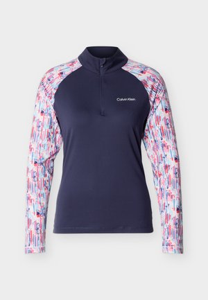 Dugih rukava mornarsko plava majica s rukavima u šarenom apstraktnom uzorku, polu-zip ovratnikom i bijelim Calvin Klein logotipom na prsima.