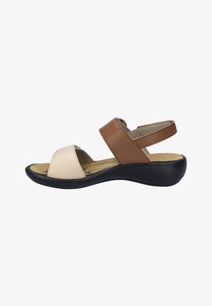 Brown and beige leather sandal with a sloped black sole, open toe, and adjustable ankle strap; cushioned footbed for support.