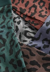 Four pairs of leggings in various colors (green, brown, gray, and purple) feature black leopard print patterns, stacked together.