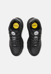 Black sneakers with a smooth leather upper, textured laces, and rounded rubber sole. Features logo on tongue and vibrant yellow insole.