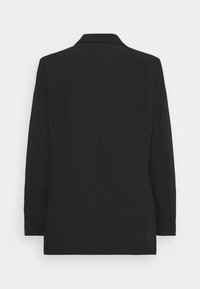 Blazer noir à manches longues avec un col classique, vu de dos sur un fond blanc uni.