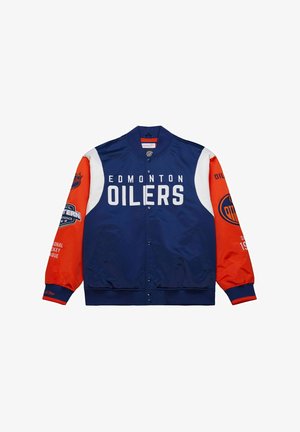 Giacca bomber degli Edmonton Oilers con corpo blu, maniche arancioni, accenti bianchi e logo prominente. Presenta bottoni a pressione e branding NHL.