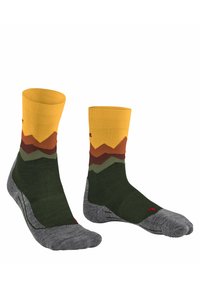 Calze lunghe fino al ginocchio con un motivo montano giallo, arancione, verde e marrone, con punta e tallone rinforzati grigi. Realizzate in un tessuto elasticizzato.