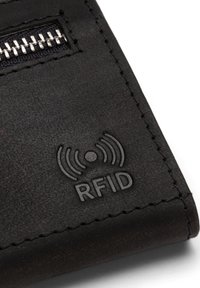 Black leather wallet featuring a zipper, RFID logo, and textured surface. Stitched edges and shiny zipper teeth are visible.