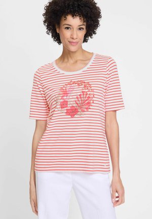Short-sleeve striped t-shirt in coral and white with floral embroidery in the center. Features a rounded neckline and relaxed fit.