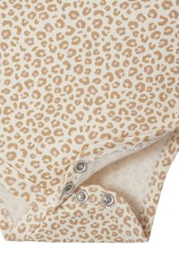 Leopard print onesie in cream and beige, featuring snap fasteners at the bottom, soft cotton material, and contrasting stitching.