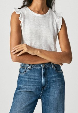 Light gray sleeveless top with ruffled shoulder accents, paired with high-waisted blue denim jeans. Soft texture with a casual fit.