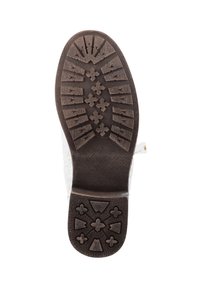 Semelle en caoutchouc brun avec un motif de texture, présentant des formes de diamant et des rainures pour l'adhérence. Partie supérieure transparente en contour.