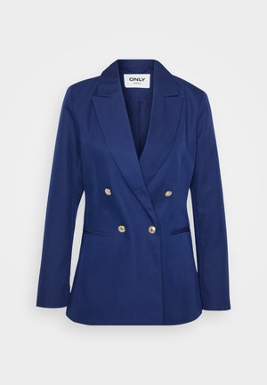 Blazer azul-marinho de dupla abertura com tecido texturizado, lapelas recortadas e detalhes em botões dourados. Apresenta dois bolsos laterais.