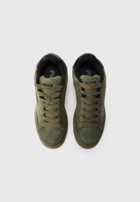 Pair of olive green suede FILA sneakers with brown laces and gum soles viewed from above on a white background