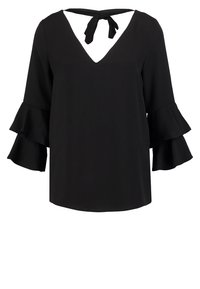 Blouse noire à encolure en V, lien à l'arrière et manches cloche à volants, présentée sur fond blanc.