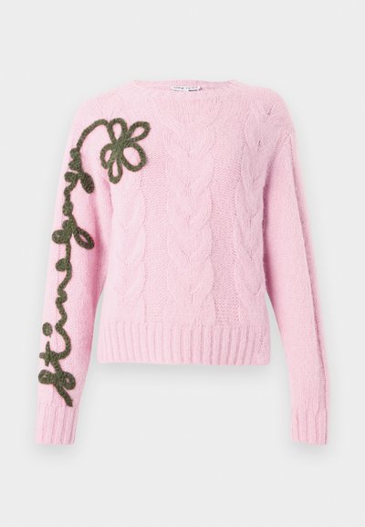 Różowy sweter z dzianiny warkoczowej z zielonym haftowanym wzorem kwiatowym na lewym rękawie. Miękka tekstura z prążkowanymi mankietami i dolnym brzegiem.