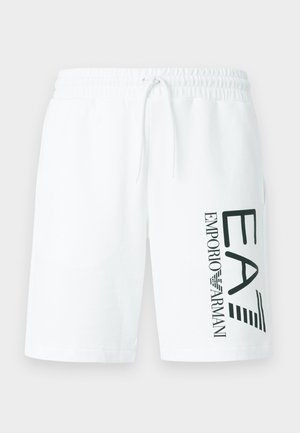 Calções de algodão branco com cintura elástica e cordão ajustável. Apresentam logotipo verde impresso "EA7 EMPORIO ARMANI" no lado esquerdo.