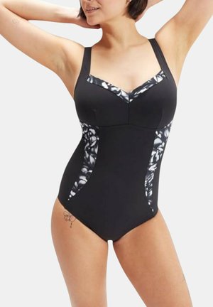 Costume intero nero con spalline larghe, scollatura a V e pannelli laterali floreali bianchi. Presenta un tessuto liscio e un design aderente.