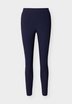 Granatowe legginsy o dopasowanym kroju z wysokim pasem, bezszwowe, sięgające do kostek, prezentowane na białym tle.