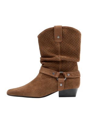 Bottine en daim marron avec tige perforée, shaft souple, sangle tressée, garniture argentée et talon bas empilé.