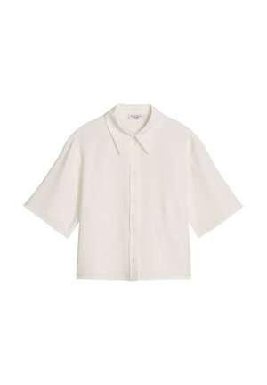 Chemise blanche à manches courtes avec boutons, col large et coupe ample, présentée à plat sur un fond blanc.