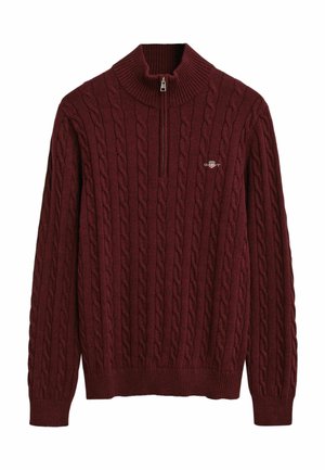 Bordeaux kabelgebreide trui met een hoge kraag en een kwart-rits. Heeft ribgebreide manchetten en onderrand, met een klein logo op de borst.