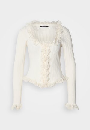 Λευκό ριμπ πλεκτό πουλόβερ με μακριά μανίκια και τετράγωνο ντεκολτέ, διακοσμημένο με βολάν και δαντέλα στα περιθώρια και στην μπροστινή πλευρά.
