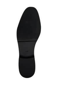 Suela de zapato negra con superficie texturizada, forma curva y bordes suaves. Presenta una ranura central y una impresión de marca visible en el diseño.