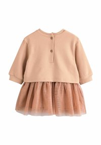 Ljusbeige topp med rund hals och knäppning, parat med en genomskinlig, glittrig brun tyllkjol. Mjukt tyg med ett lager-på-lager utseende.