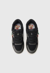 Black athletic shoes with gray accents, round toe, textured fabric upper, thick laces, and printed insole featuring a character design.