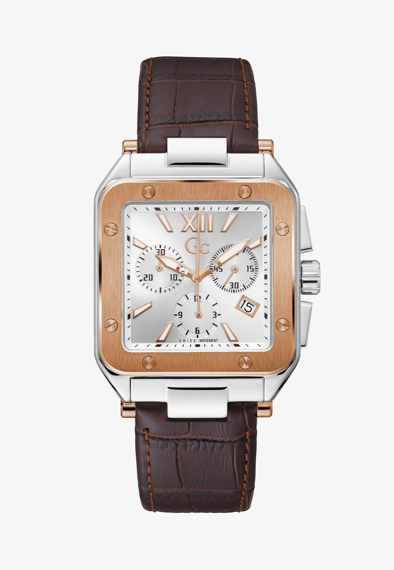 Montre rectangulaire avec un cadran argenté, des accents en or rose et un bracelet en cuir de crocodile marron. Fonction chronographe et affichage de la date présents.