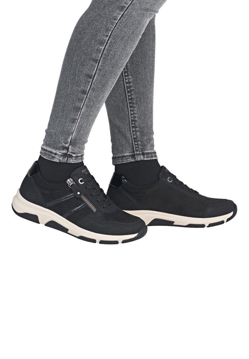 Schwarze Wildledersneaker mit glatter Textur, ausgestattet mit einem Reißverschlussdetail, weißer Sohle und schwarzen Akzenten. Entwickelt für Komfort und Unterstützung.